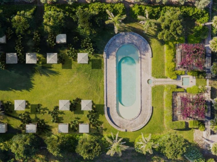 Outdoor swimming pool and garden of the exclusive Vestige Son Vell. Menorca island. 