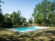 Countryside swimming pool, with trees providing shade. (Brentina)