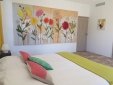 Suite room 1, with a small sitting area and a private balcony. 180 x 200 cm bed (high quality bedding).  Bathroom with a large walk-in shower. Air-conditioned room, Internet access.