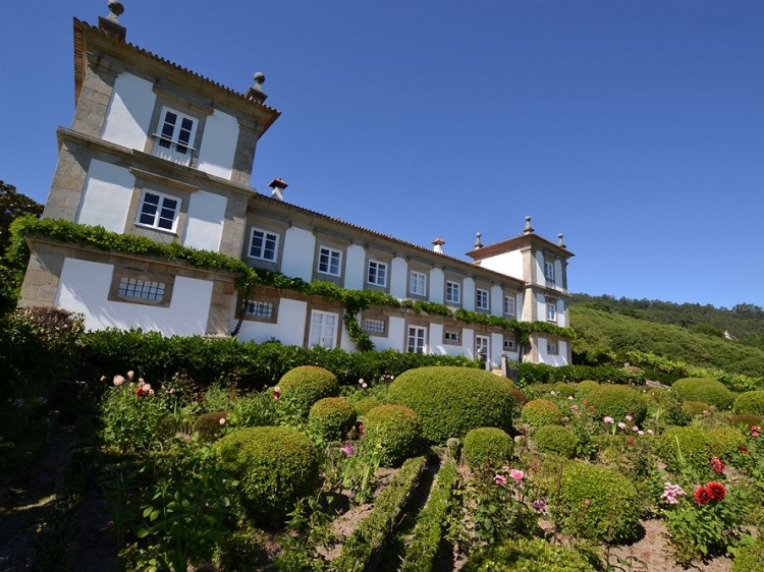 Old mansion surrounded by green garden