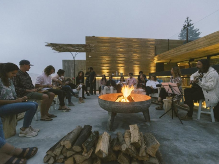 People sitting around a cozy fireplace